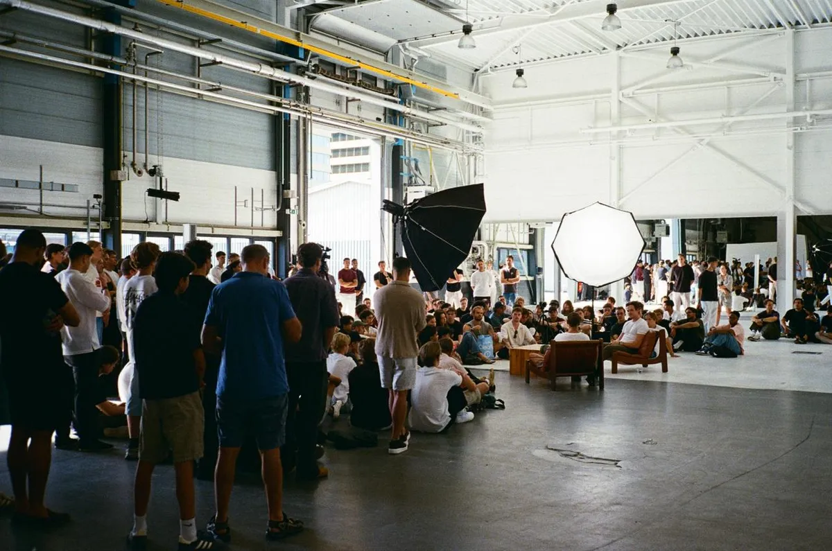A crowd gathered around a small stage at a context meetup